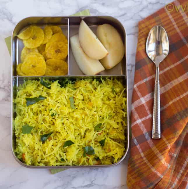 Lemon Sevai or Lemon Flavored Instant Rice Vermicelli served in a metal lunchbox with a metal spoon on the right side