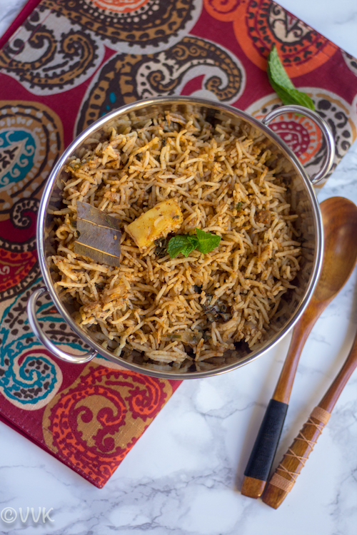 Paneer Biryani ready and served on a fabulous piece of fabrics and a wooden spoon