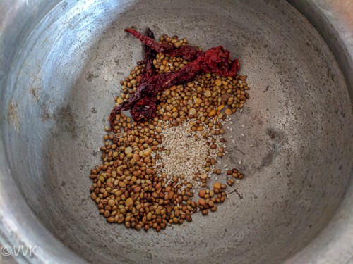 adding sesame seeds to the puliodarai powder