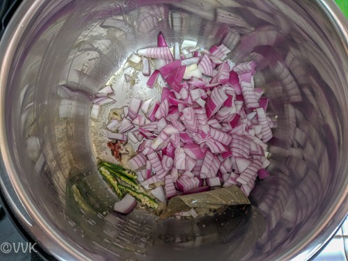 Adding split green chilies, ginger garlic paste and onions
