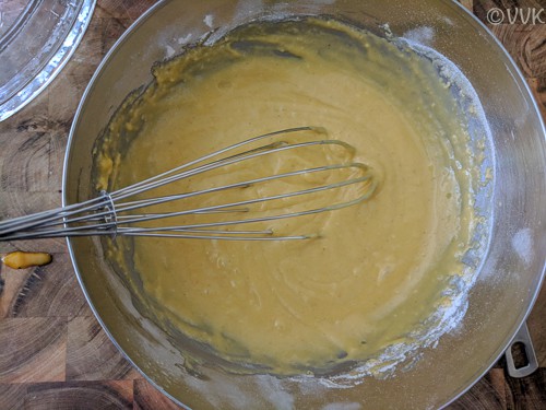 Pouring the cake batter into a cake pan and spreading it evenly