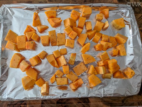 placing the butternut squash in a baking a tray lined with foil