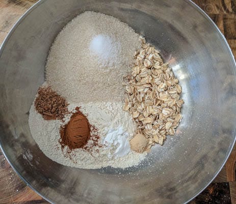 Combining flour, oats, sugar, baking powder, salt and spices