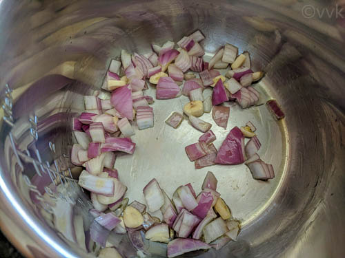Adding chopped onion and garlic cloves