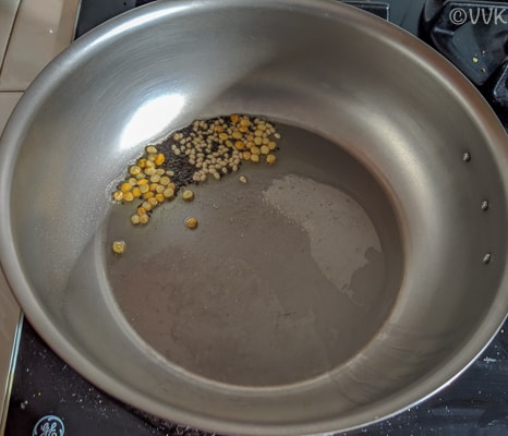 Adding the mustard seeds, urad dal, chana dal and hing.