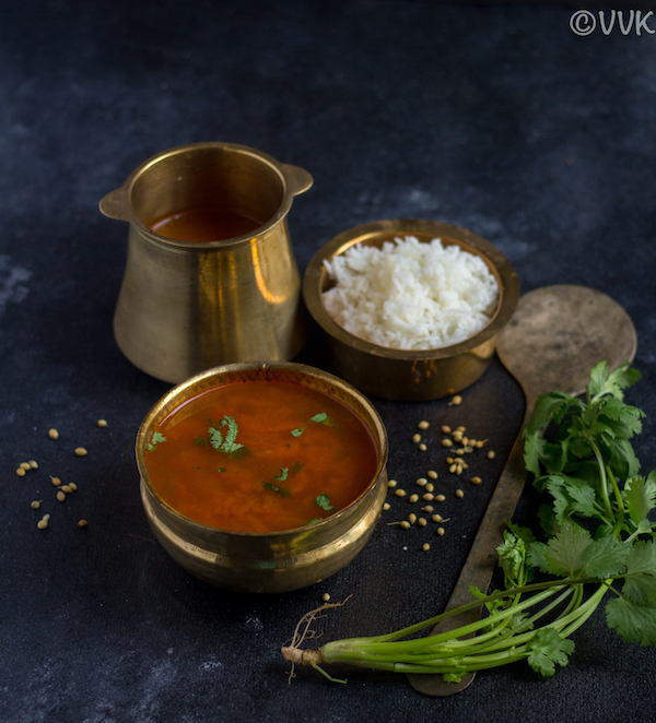 kerala style instant rasam in brassware with rice on the top