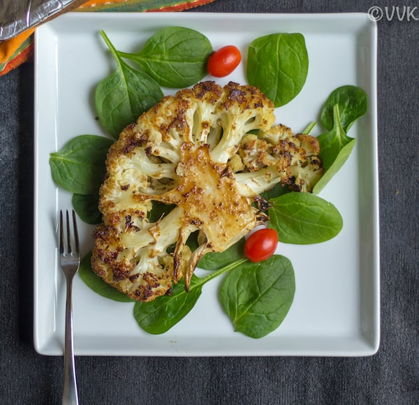 Roasted Cauliflower Steaks Served Hot with Spinach