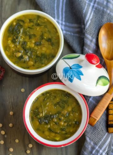 Instant Pot Green Lentils and Spinach Curry - Dal Palak - Beautiful Composition of the Dish with Two Wooden Spoons and Chili Pepper on the Side