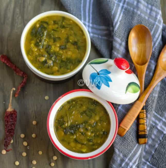 Instant Pot Green Lentils and Spinach Curry - Dal Palak - Beautiful Composition of the Dish with Two Wooden Spoons and Chili Pepper on the Side