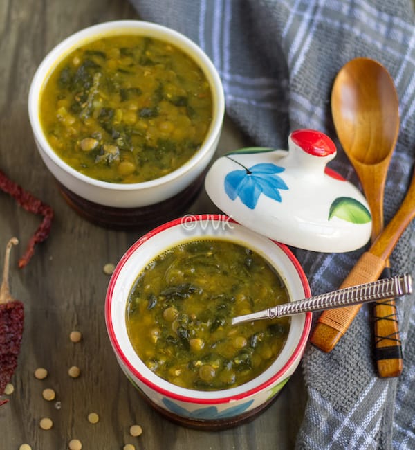 Instant Pot Green Lentils and Spinach Curry - Dal Palak - Beautiful Composition of the Dish with Two Wooden Spoons and Chili Pepper on the Side