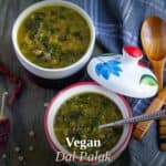 vegan green lentils and spinach curry with text overlay for pinterest