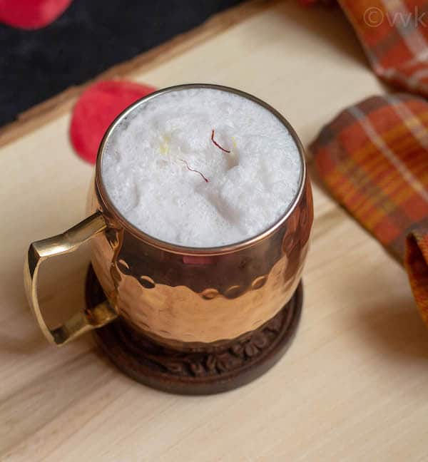 close up shot of coconut milk kheer in copper mug
