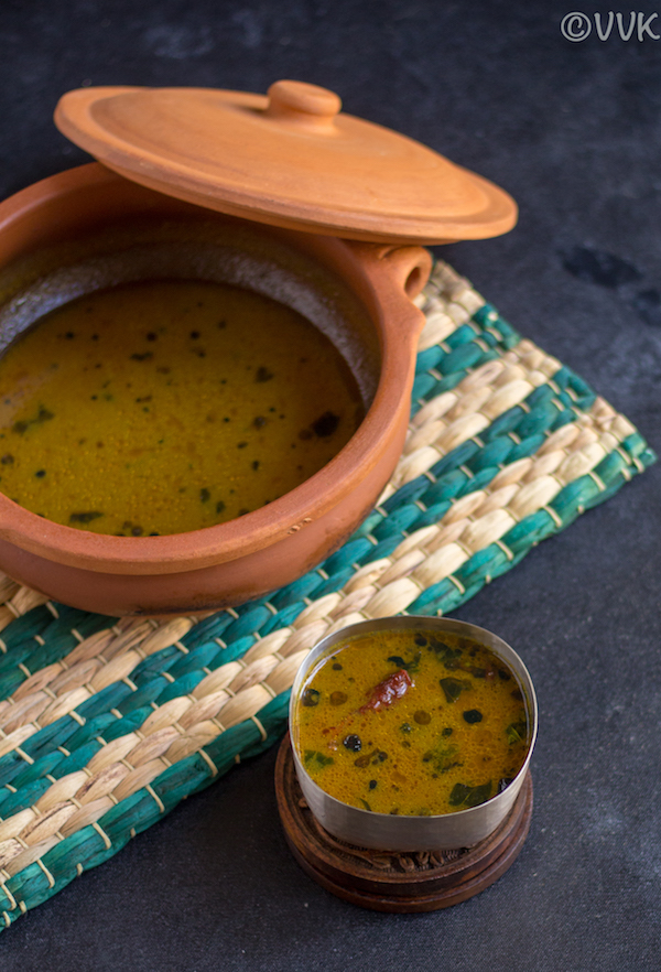 vathal kuzhambu in a small bowl and a clay with vathal kuzhambu on the left side