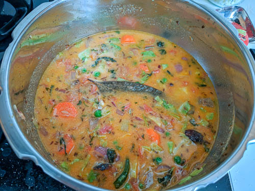 delhi veg biryani adding rice and water