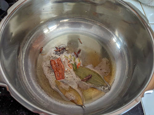 hyderabadi biryani step - adding whole spices