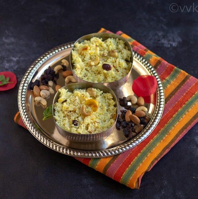 mishti pulav in two bowls on a plate full of nuts and raisins