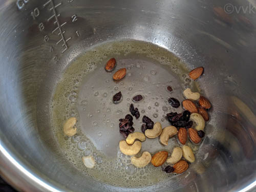 kashmiri pulao step - adding nuts and raisins