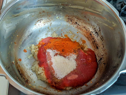 paneer makhani biryani, adding tomato puree and spices