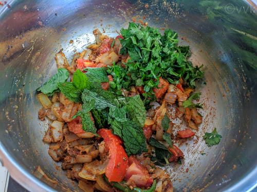 veg biryani adding mint and cilantro