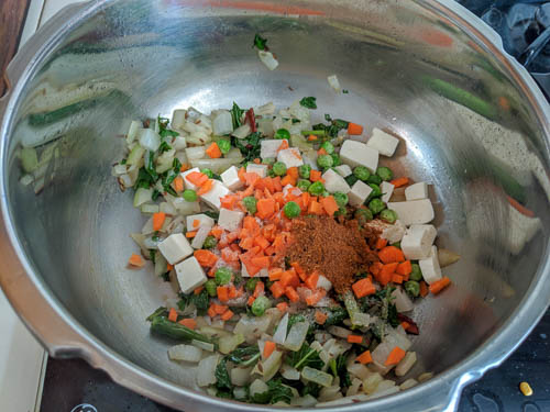 yakhni pulav adding veggies and spices