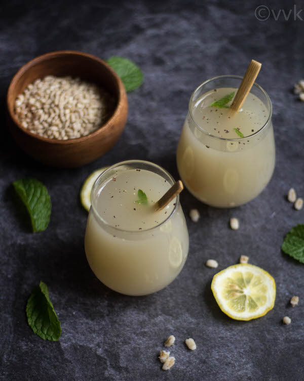 barley water lemonade in two glasses with barley on the side