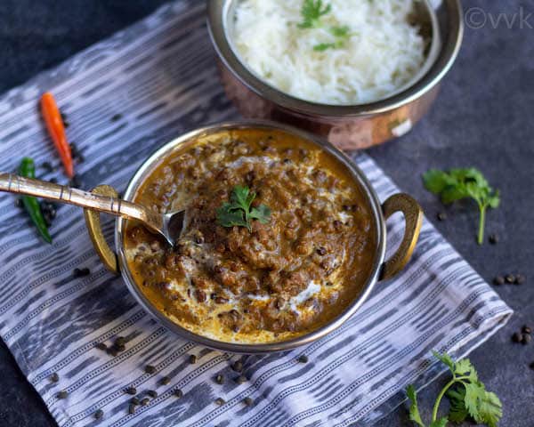 kaali dal in brassware bowl with rice on top