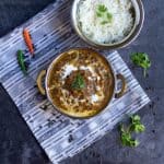 Instant pot kali dal in bowl with rice on the side