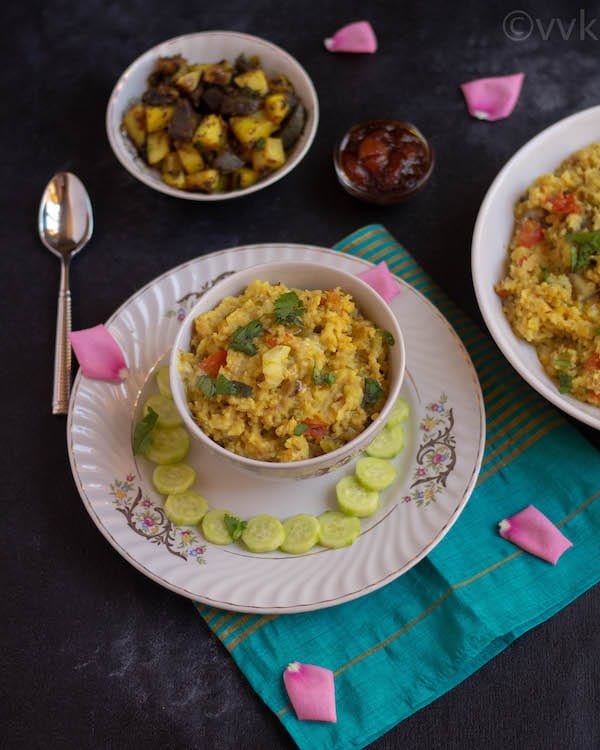 moong dal khichdi in a white ceramic bowl on a plate