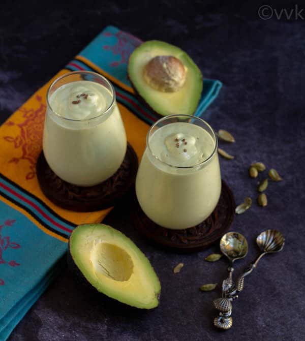 creamy and rich avocado yogurt smoothie in two glass jars