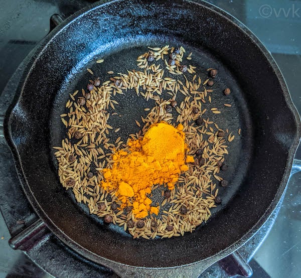 adding turmeric powder to the spices