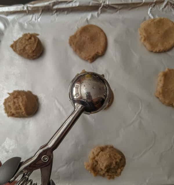 spreading oil on the cookie scooper