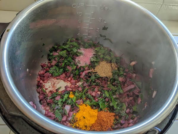 adding spices to mixed dal tadka