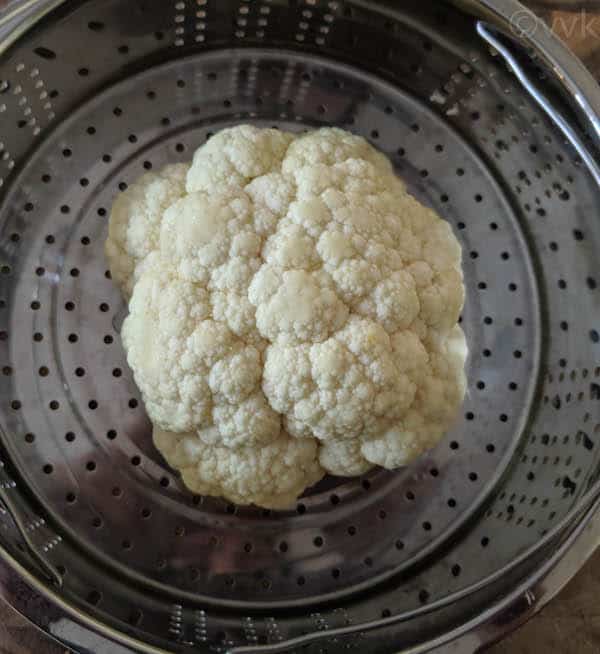 placing cauliflower in the steamer basket
