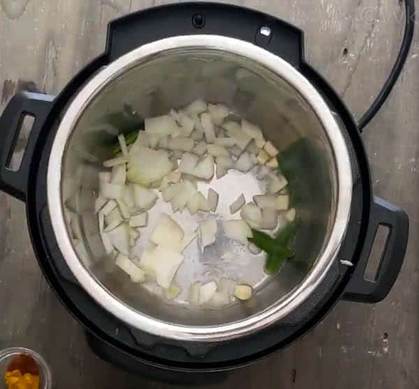 cauliflower soup adding green chilies, garlic and onion