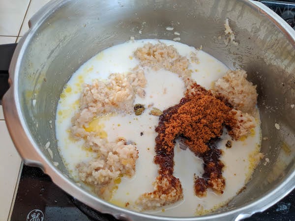 adding milk, jaggery to sakkarai pongal