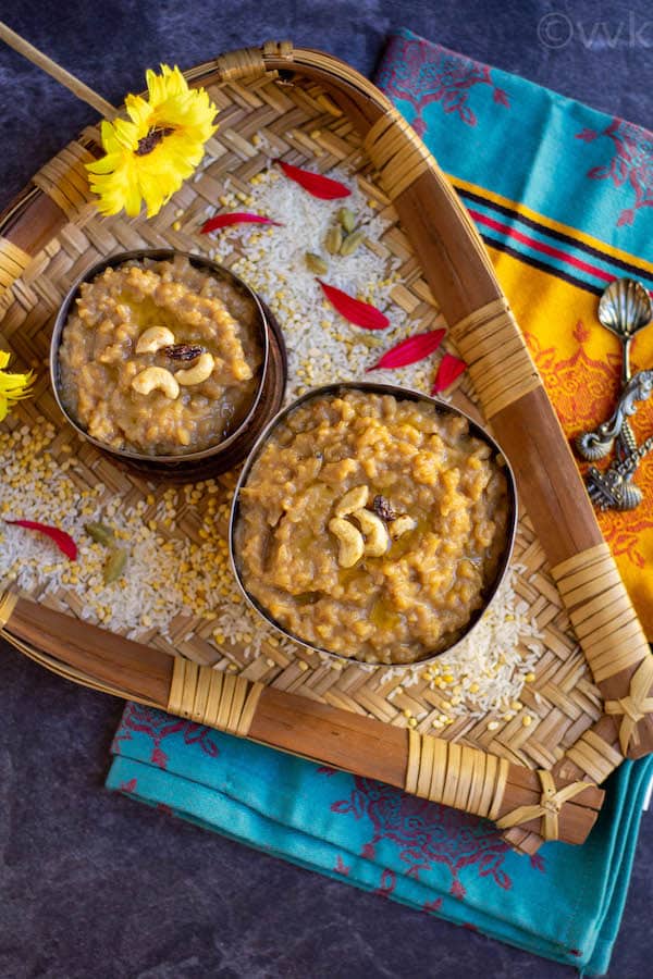 sweet pongal placed in two bowls on top a muram filled with rice and flowers