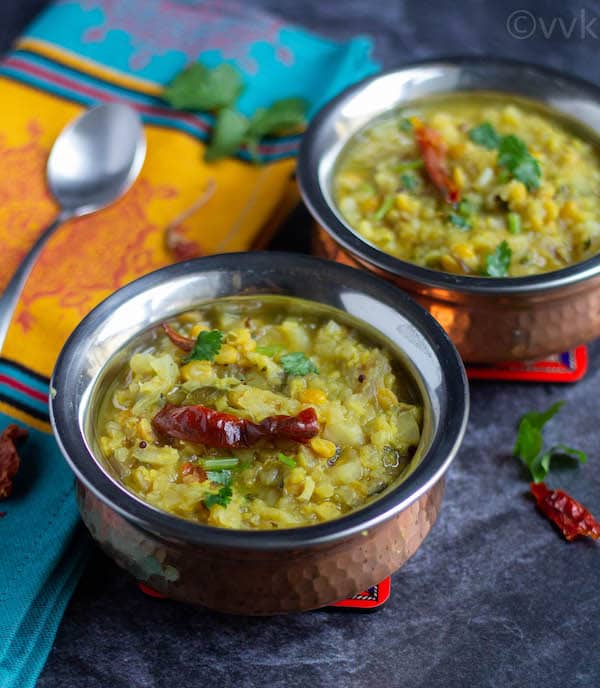 cabbage kootu in two serving bowls with spoon on the side