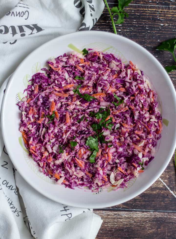 top angle view of cabbage coleslaw in a white bowl