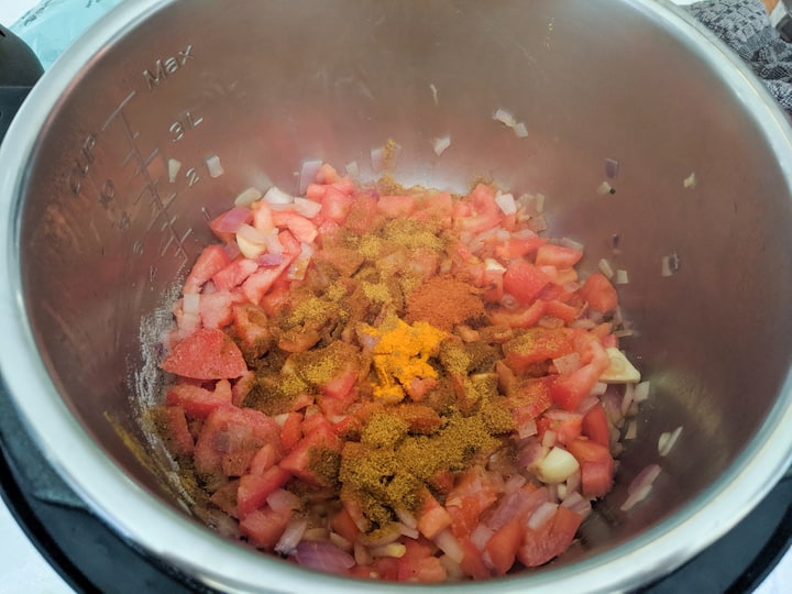 adding tomatoes and spices