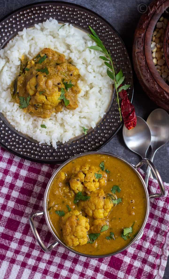 overhead shot of cauliflower kurma kuzhambu served in a kadai bowl with rice on the side