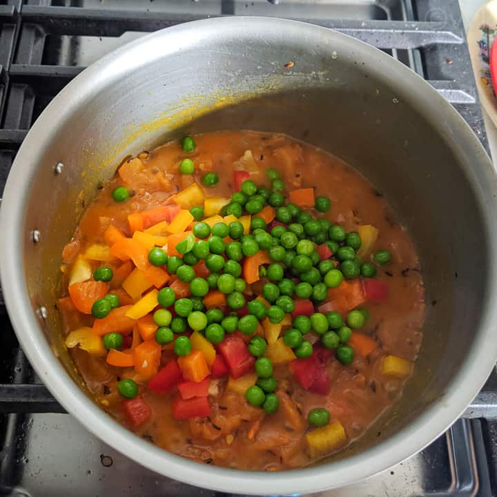 adding peas and bell peppers