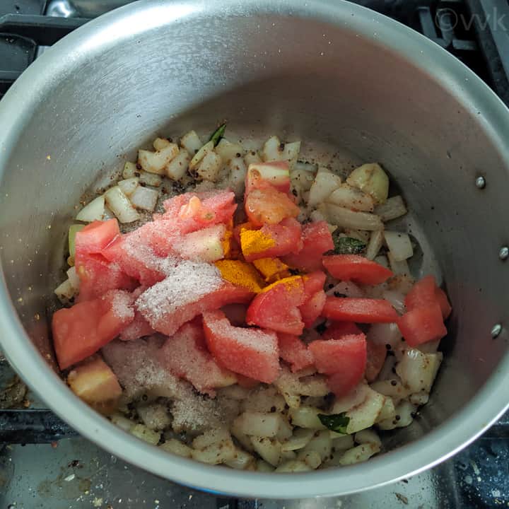 adding tomatoes, salt and turmeric powder