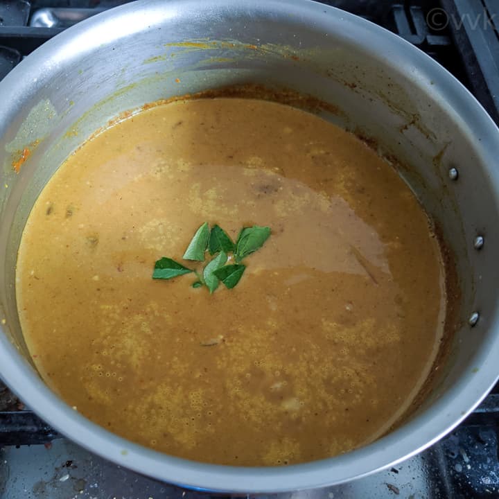 adding coconut milk and curry leaves