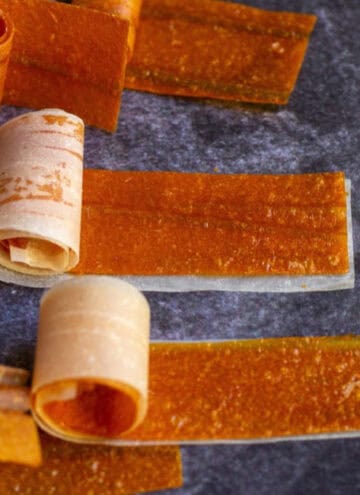 square image of mango roll ups with parchment paper