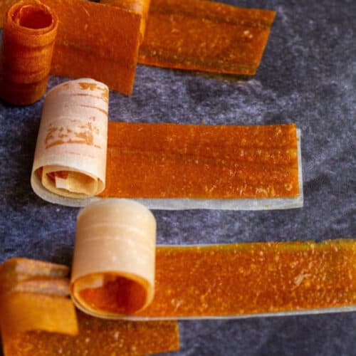 square image of mango roll ups with parchment paper