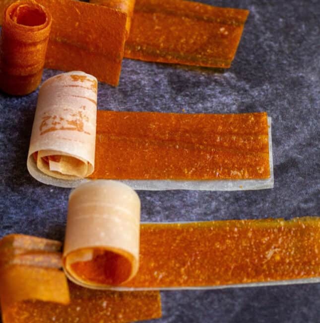 square image of mango roll ups with parchment paper