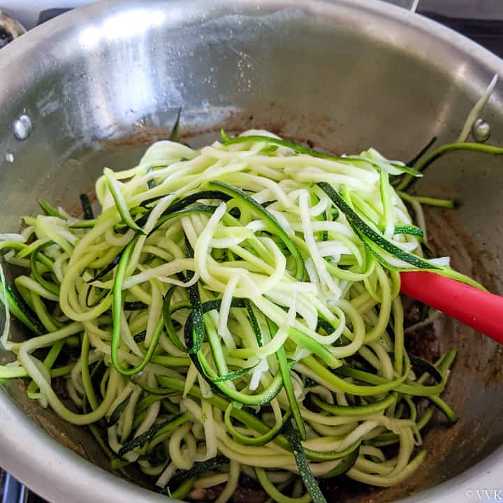 adding the zoodles to the sauce