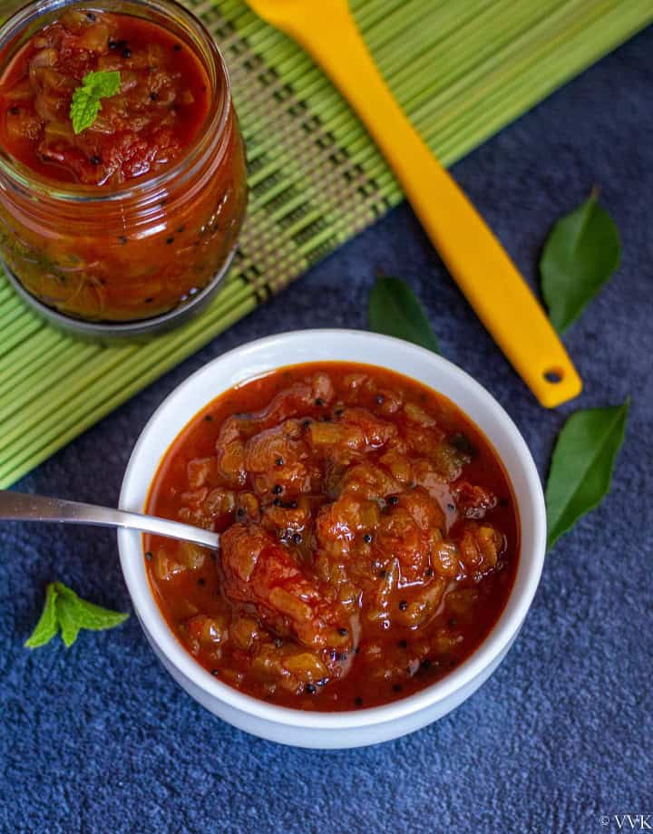 instant pot tomato onion relish in a white bowl with a spoon inside