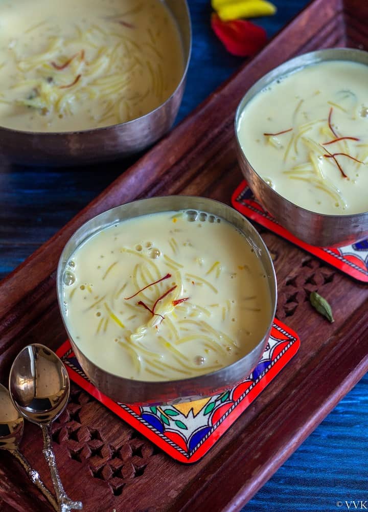 semiya payasam served in a silverware placed on a wooden tray