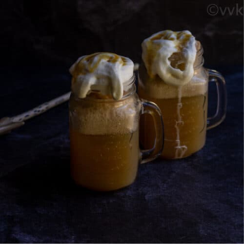 square image of butterbeer with a wand on the side served in mason jars